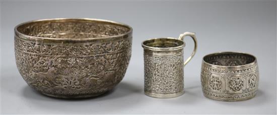 An Indian white metal sugar bowl, a cup and a serviette ring.
